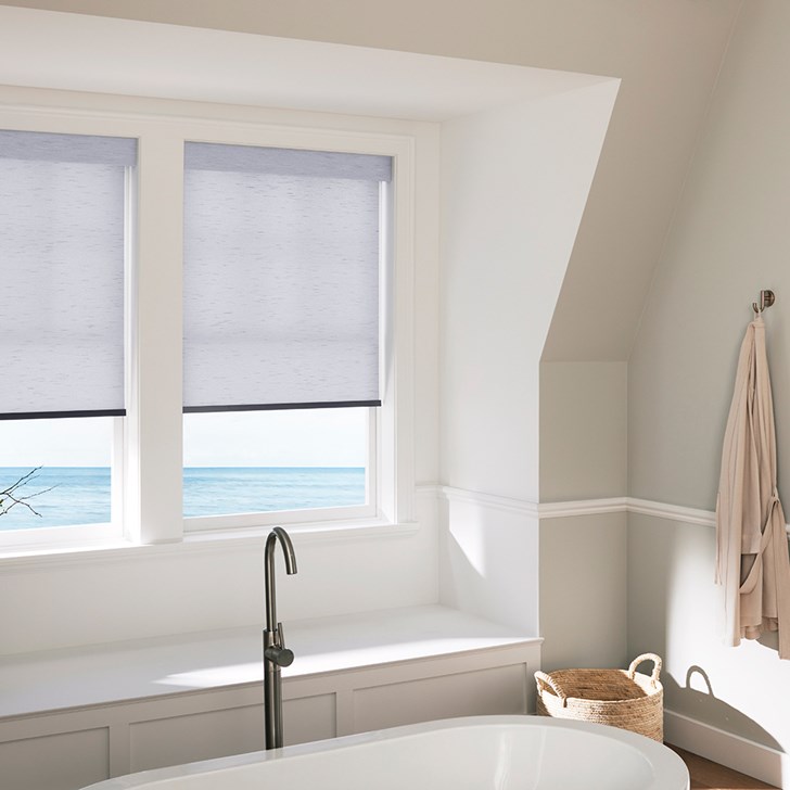 The Motorized Light Filtering Roller Shades in the Milan Indigo color with the Fabric Wrapped 4in. Cornice.